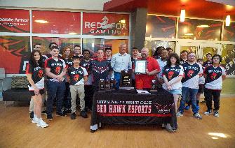 Red Hawk Esports team stands with Mayor Hank Guess, CVCC President Garrett Hinshaw, and Esports head coach Cody Dalton. 