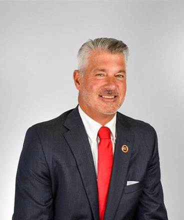 Dr. Hinshaw, president of Catawba Valley Community College, photographed against a gray backdrop.